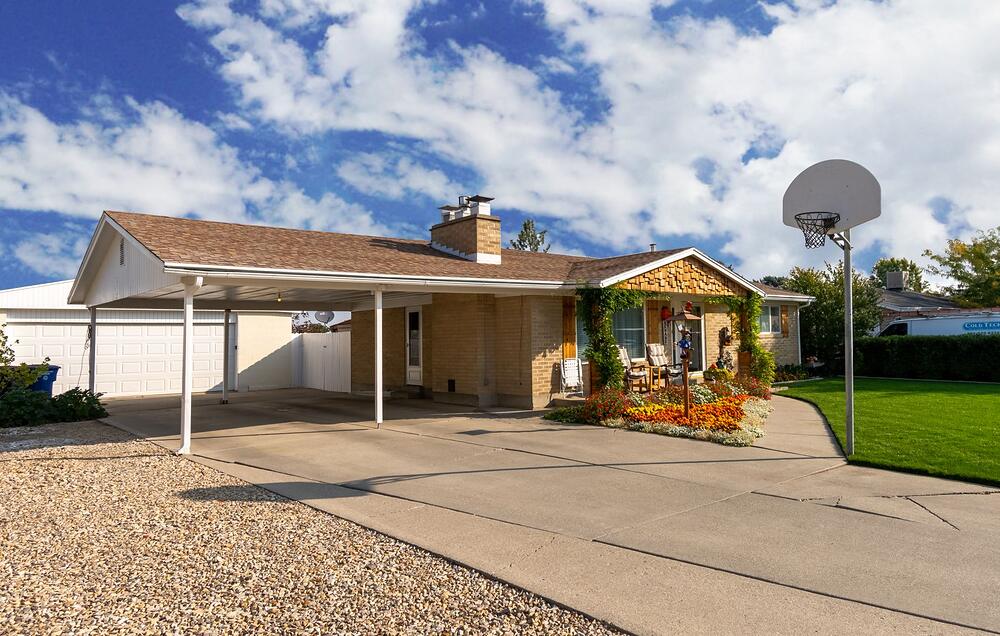 A 1960s brick ranch house with an attached carport