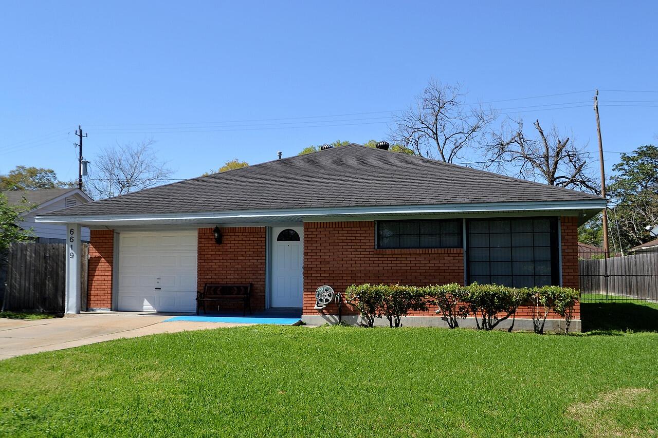 Single-story brick ranch houses on a suburban street