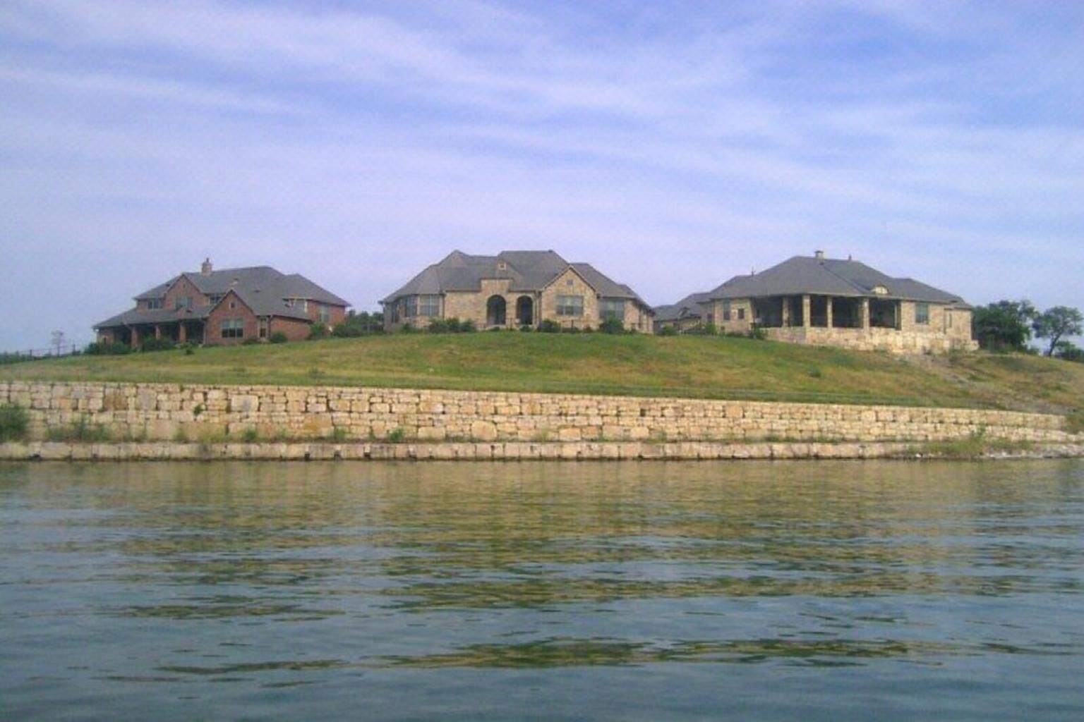 Houses on a hill above a lake