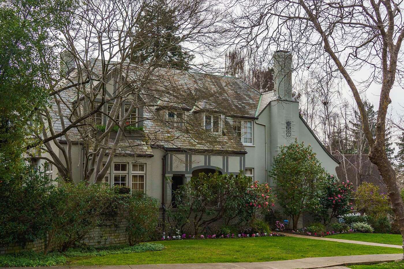 A brick Tudor cottage with a steep front gable